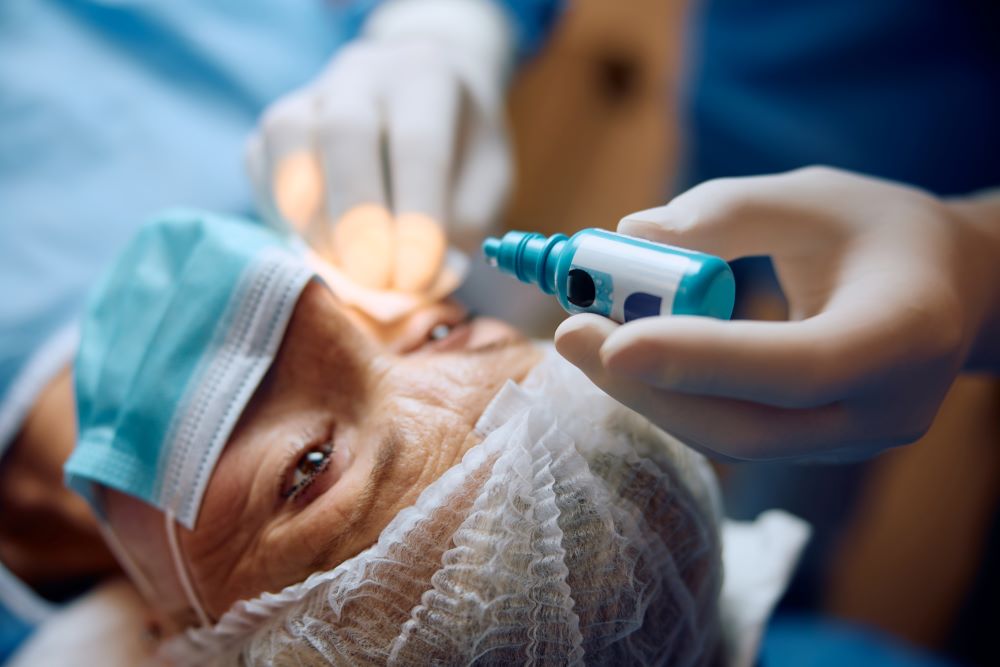 Close up of ophthalmologist giving anesthetic drops before eye surgery to his patient