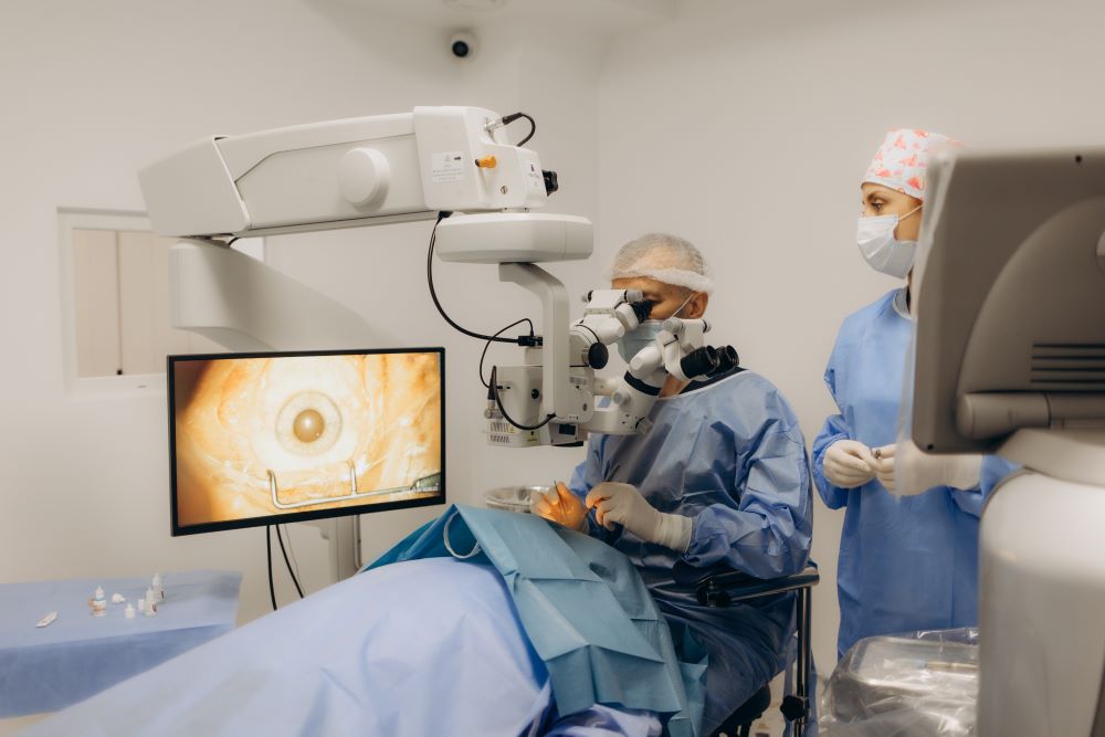 surgeon and his medical team performs precise eye surgery on an elderly patient